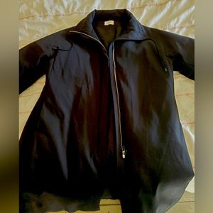 The Row oversize lined coat with mock neck, concealed zipper and flair cut.